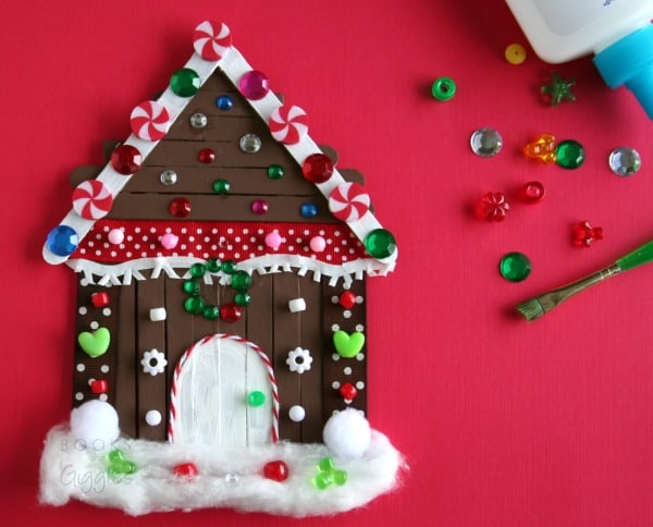 Kids' gingerbread house craft made with popsicle sticks and non-food items from the craft box. This is a big kid activity that will hold their attention! Includes a story to accompany the craft.